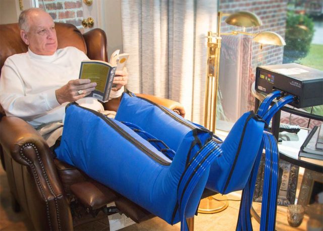 patient relaxing while wearing VasoCAREpneumatic compression device.